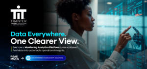 Woman interacting with a digital dashboard displaying data charts, representing Tranter Smart Solutions' Monitoring Analytics Platform that turns scattered field data into actionable insights