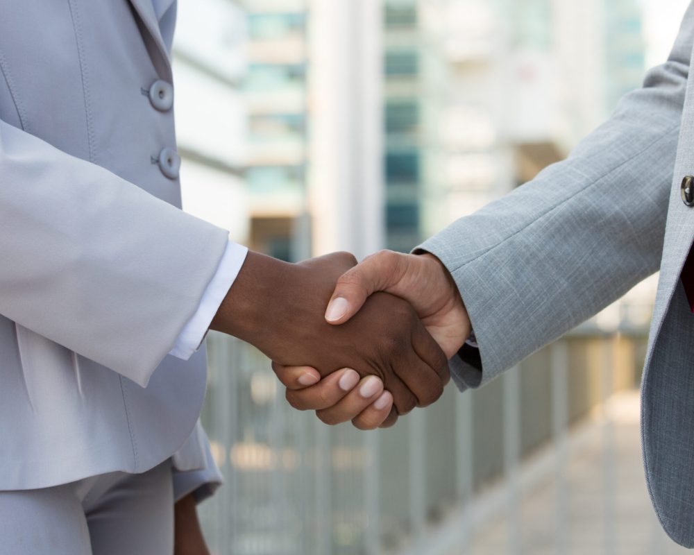 multiethnic leaders greeting each other in city