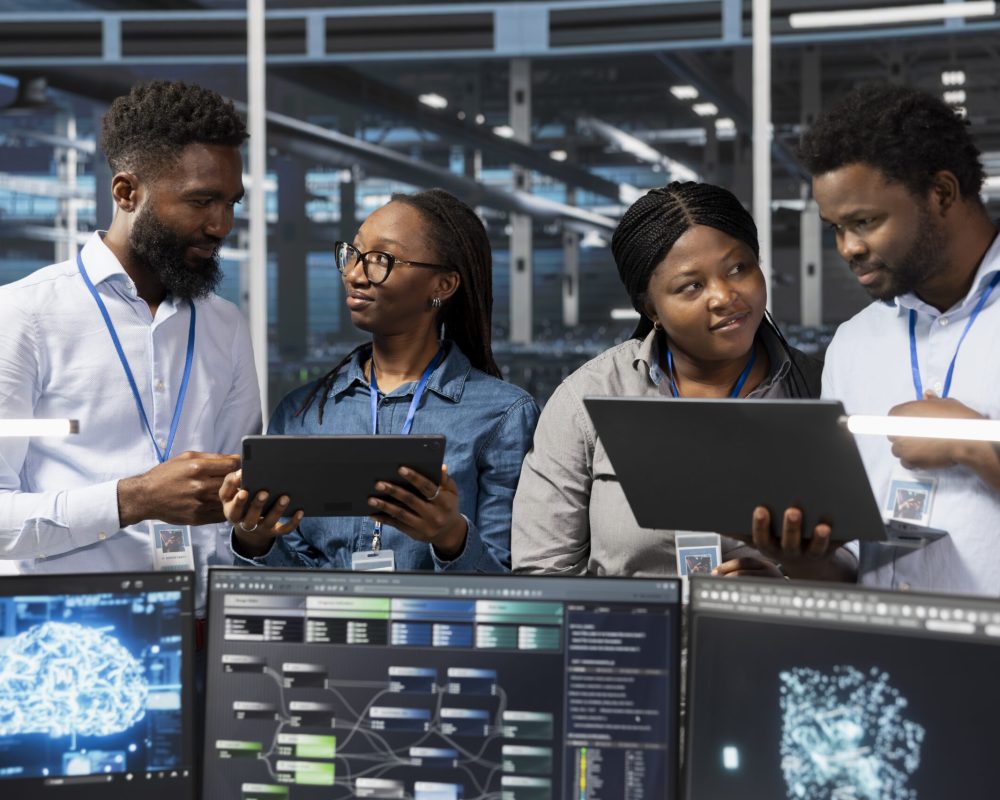 Teamworking server room colleagues use artificial intelligence to perform computing tasks. Data center engineering team doing brainstorming, working together, using AI for machine learning workloads